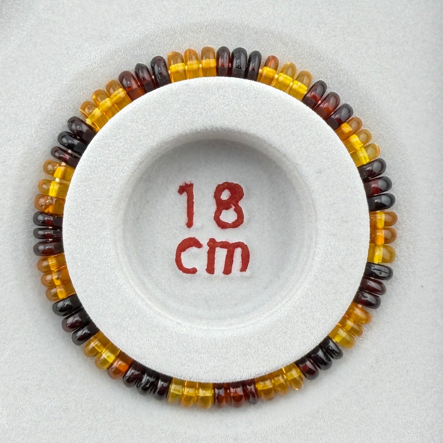 Bernstein (bunt) – Button-Armband 3×6 mm (elastisch, ca. 19 cm)