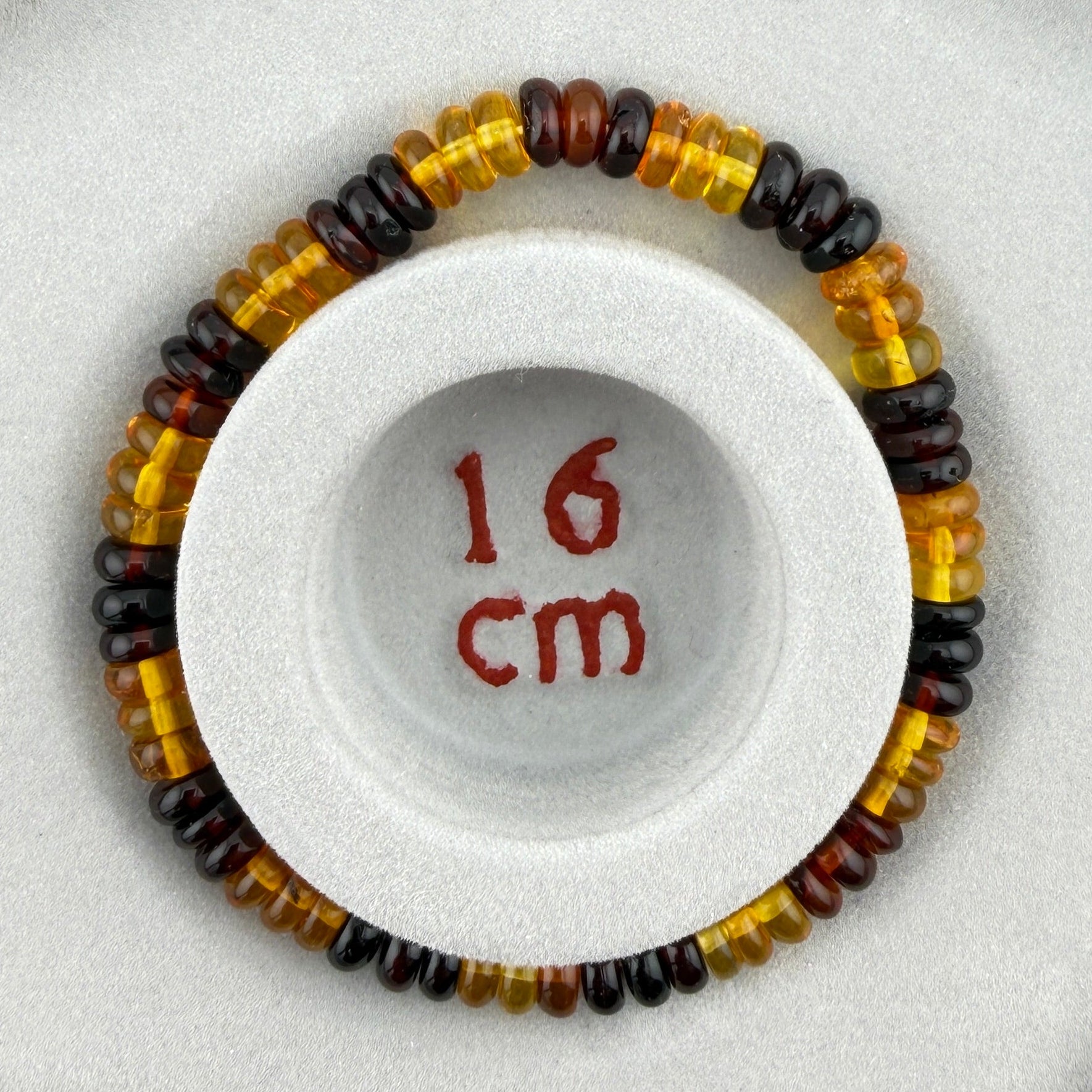 Bernstein (bunt) – Button-Armband 3×6 mm (elastisch, ca. 19 cm)